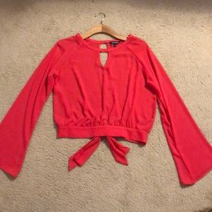 A cropped, salmon long sleeve